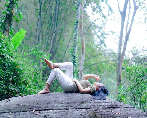 Person doing gentle outdoor stretches in nature